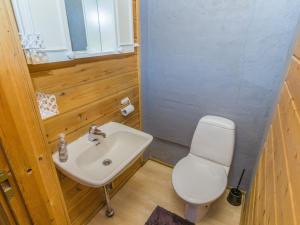 a small bathroom with a sink and a toilet at Holiday Home Heikkilä by Interhome in Kuusamo +2 photos