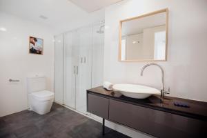 a bathroom with a sink and a toilet and a mirror at Aspasios Atocha Apartments in Madrid +34 photos