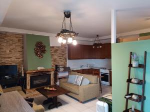 a living room with a couch and a fireplace at A quiet apartment in Corfu Town
