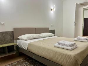 a bedroom with a bed with two towels on it at Al Duomo Suites in Monreale +54 photos