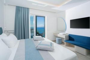 a hotel room with a large bed and a television at Sea View Deluxe Apartments in Vico Equense