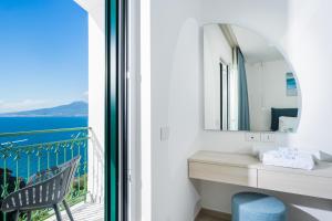 a bathroom with a view of the ocean from a balcony at Sea View Deluxe Apartments in Vico Equense