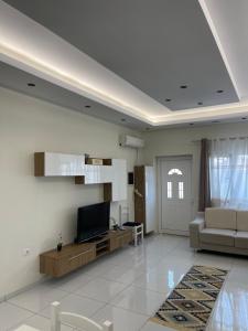 a living room with a couch and a television at Franco Apartments in Tirana