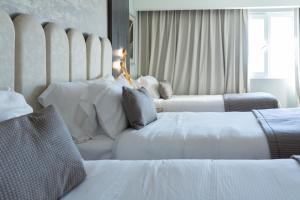 En eller flere senger på et rom på Hotel HW High Wellness