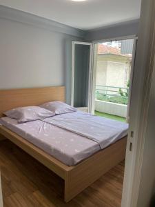 a bed in a room with a large window at 50m2 Climatisé Proche Mer in Nice