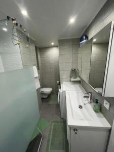 a bathroom with a sink and a toilet and a mirror at 50m2 Climatisé Proche Mer in Nice