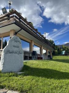 a building with a train on top of it at Chalet Baita del Sole in Teglio