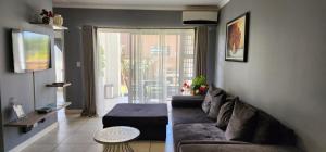a living room with a couch and a large window at 521 at The Blyde in Pretoria