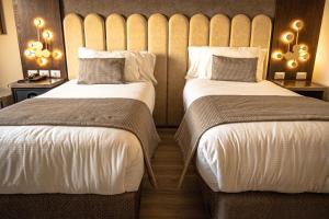 En eller flere senger på et rom på Hotel HW High Wellness