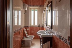 a bathroom with a sink and a toilet and a mirror at Saba's House in Naples +28 photos