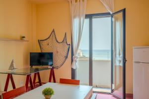 a living room with a view of the ocean at Rivabella Gallipoli-La spiaggia a due passi in Rivabella