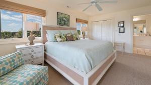 a bedroom with a bed and a chair and a window at Maison Blanche home by Peace Vacations in Georgetown