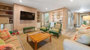 a living room filled with furniture and a table at Maison Blanche home by Peace Vacations in Georgetown +38 photos