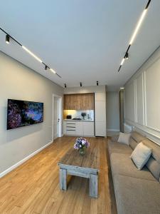 a living room with a couch and a table at Home Side Apartment in Batumi