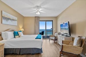 a bedroom with a bed and a flat screen tv at Phoenix 6 Unit 1213 in Orange Beach