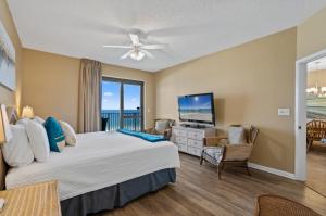 a bedroom with a large bed and a television at Phoenix 6 Unit 1213 in Orange Beach +44 photos