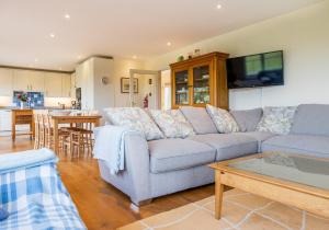 a living room with a couch and a table at Garth - a family home by the sea in Newport Pembrokeshire