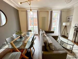 a living room with a couch and a glass table at Bloomsbury Residences in London