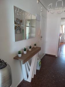 a room with a table with potted plants on it at Euromar Playa Cullera frente al mar con garaje in Cullera