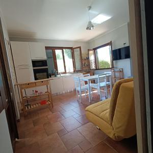 a living room with a couch and a table and chairs at Macchie Basse Guest House - Agriturismo in Pescia Fiorentina