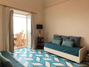 a bedroom with a bed and a balcony at Limoni in Praiano +53 photos