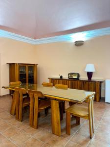 a dining room with a wooden table and chairs at La Locanda Del Castello in Ocre
