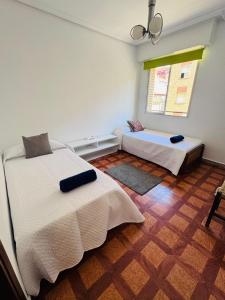 a bedroom with two beds and a window at Apartamento centro de Nájera in Nájera