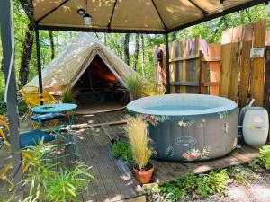 a backyard with a tent and a hot tub at CYBÈLE in Bernac +16 photos