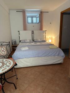 a bedroom with a large bed and a chair at Jasmina-Room in Jurandvor