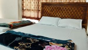 Ένα ή περισσότερα κρεβάτια σε δωμάτιο στο New Hotel Labbaik