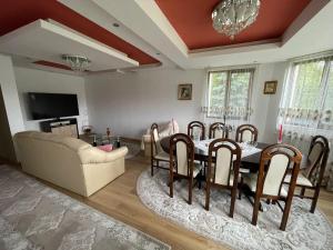 a living room with a table and chairs and a couch at Casa Iuliana Camelia in Câmpulung Moldovenesc