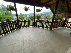 a balcony with potted plants and a wooden railing at Casa Iuliana Camelia in Câmpulung Moldovenesc