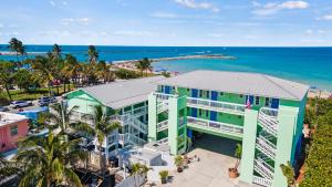an aerial view of a building next to the ocean at Oceanfront Inn, Private Balcony, 2 Full Beds #16 in Fort Pierce