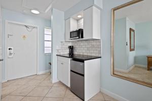 a kitchen with a counter top and a mirror at Ocean View Hotel Room with Balcony- King Bed #23 in Fort Pierce