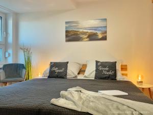 a bedroom with a bed with a laptop on it at Nordseepanorama in der Ferienwohnung de Spant in Dorum Neufeld +18 photos