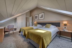 a hotel room with two beds and a desk at Boutique Villa Filaus in Dubrovnik