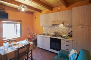 a kitchen with a table and a dining room at Baita Michele con Terrazzo e bellissima Vista Lago x 4 Persone in Aurano