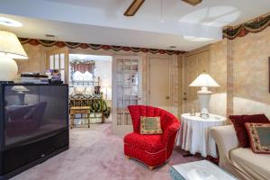 a living room with a red chair and a couch at Large and Private Guest House Apt with Patio and Views! in Danville