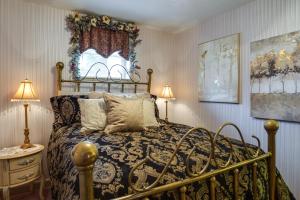 a bedroom with a bed and two lamps and a window at Large and Private Guest House Apt with Patio and Views! in Danville