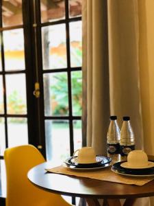 a table with two bottles of soda on it at Hospedagem Canto do Una in Barra do Una +15 photos