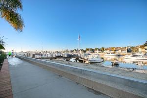 a walkway next to a marina with boats in the water at 1011 N Bayfront A & B in Newport Beach