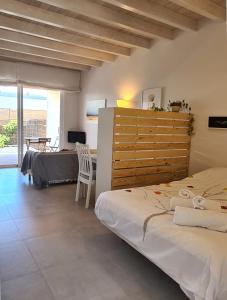 a bedroom with two beds and a desk and a table at Estudio SoleArte en Lajares in Lajares