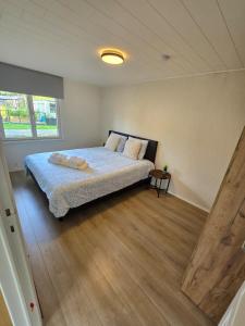 a bedroom with a large bed in a room at T'chaletje met hottub in Lanaken
