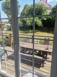 a window view of a picnic table and a bench at Domek Bananek in Orzysz +1 photo