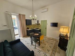 a living room with a couch and a table at Lu Màri case vacanze in Balestrate