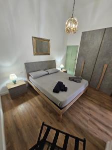 a bedroom with a bed and a chandelier at Lu Màri case vacanze in Balestrate