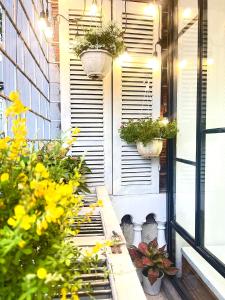 a patio with flowers and plants on a building at Sora Home - 3 mins to Hoan Kiem Lake in Hanoi