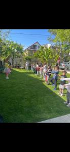 a group of children standing in a field of grass at Casa inflorita garsoniere etaj in Eforie Nord