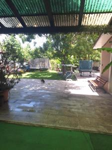 a patio with a bench and a picnic table at Casa inflorita garsoniere etaj in Eforie Nord