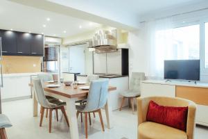 a kitchen and dining room with a table and chairs at MountSea Villa in Agios Nikolaos